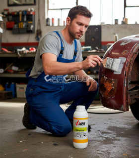 Using IMPA KELA RUST 1412 Rust Converter on a car body with a brush.