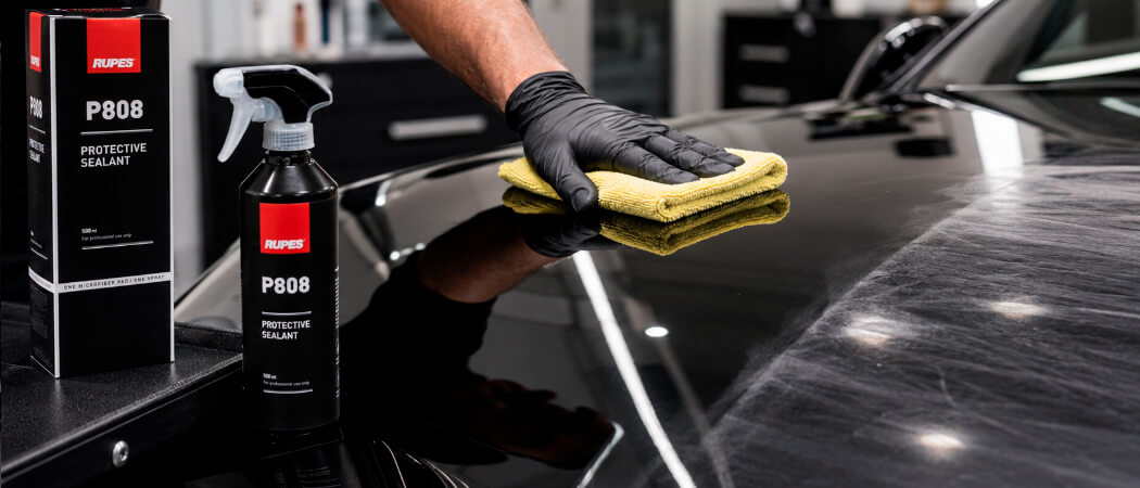 applying protective wax on car paintwork for UV protection